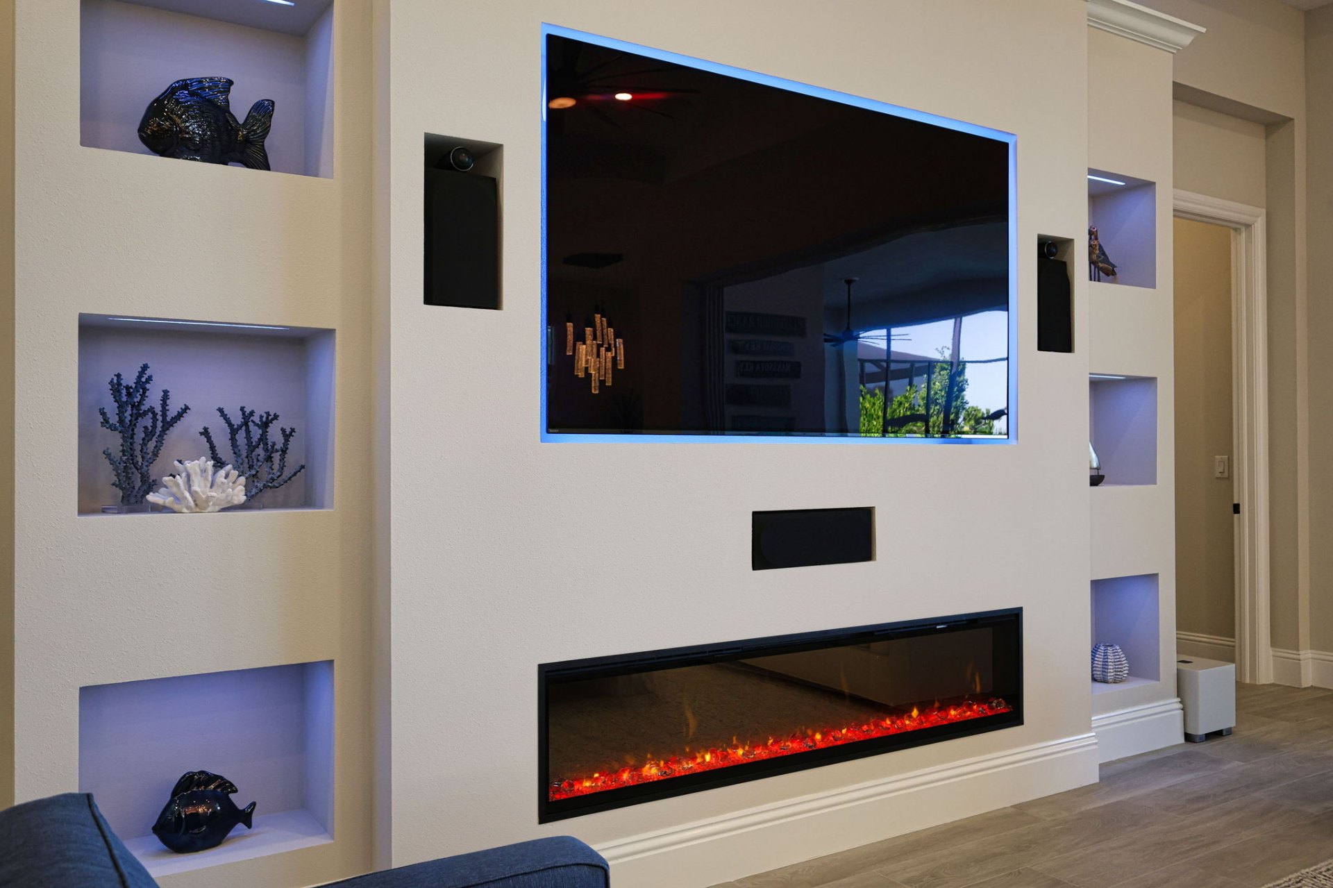 Custom built-in entertainment wall with display niches and linear fireplace
