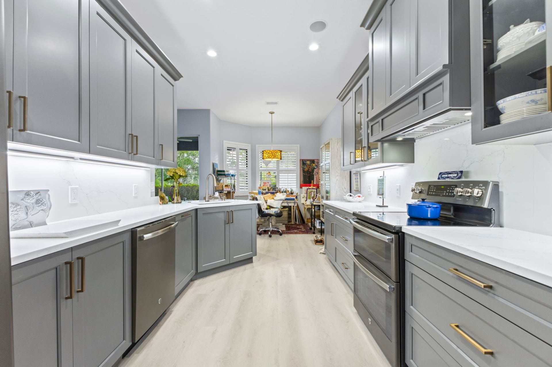 Wide view of custom shaker cabinetry in Sherwin-Williams Gauntlet Gray with quartz countertops