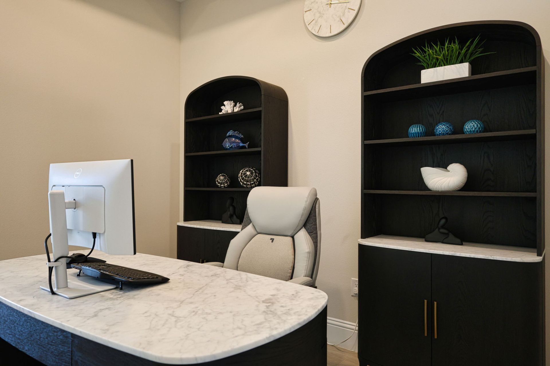 Home office detail — custom arched bookcases with coastal accessories