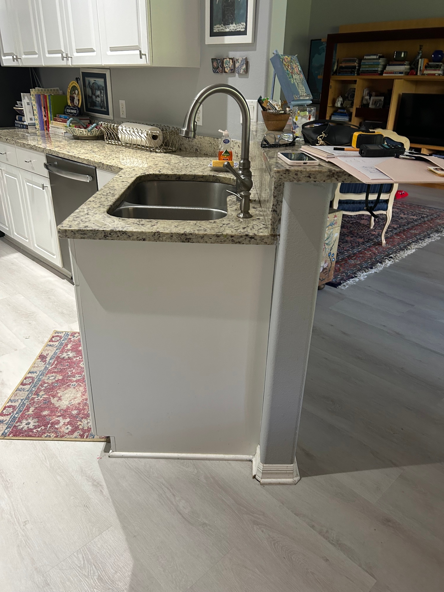 Before — original peninsula with granite countertop and undermount sink
