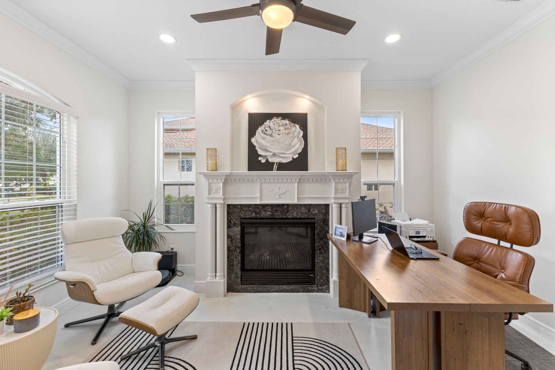 Custom home office with marble fireplace, Eames-style chair and live-edge walnut desk
