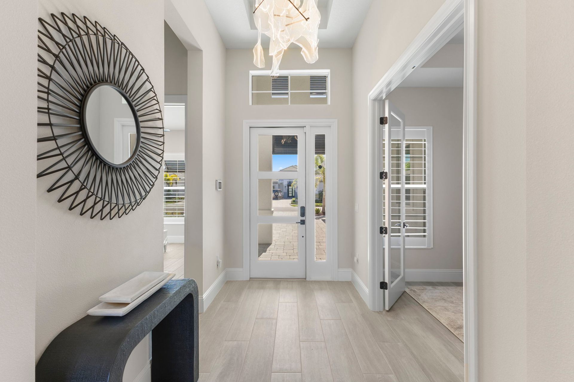 Entry foyer with statement lighting and custom console