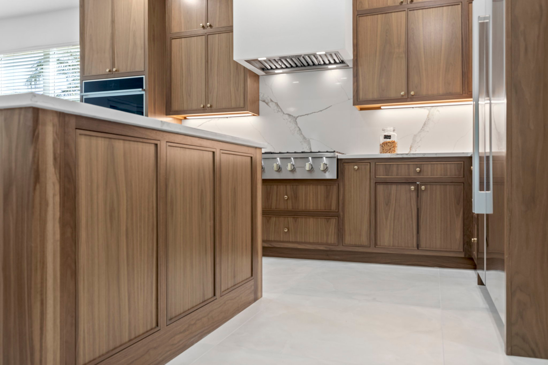 Solid walnut inset-frame kitchen cabinetry with quartz countertops in a Sarasota, FL home