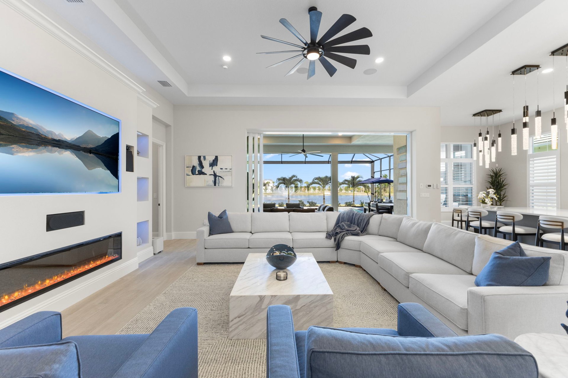 Living room with linear fireplace and lake views beyond
