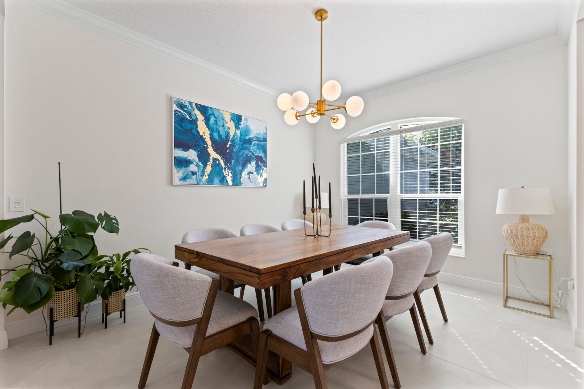 Formal dining room with solid wood table, upholstered chairs and brass globe chandelier