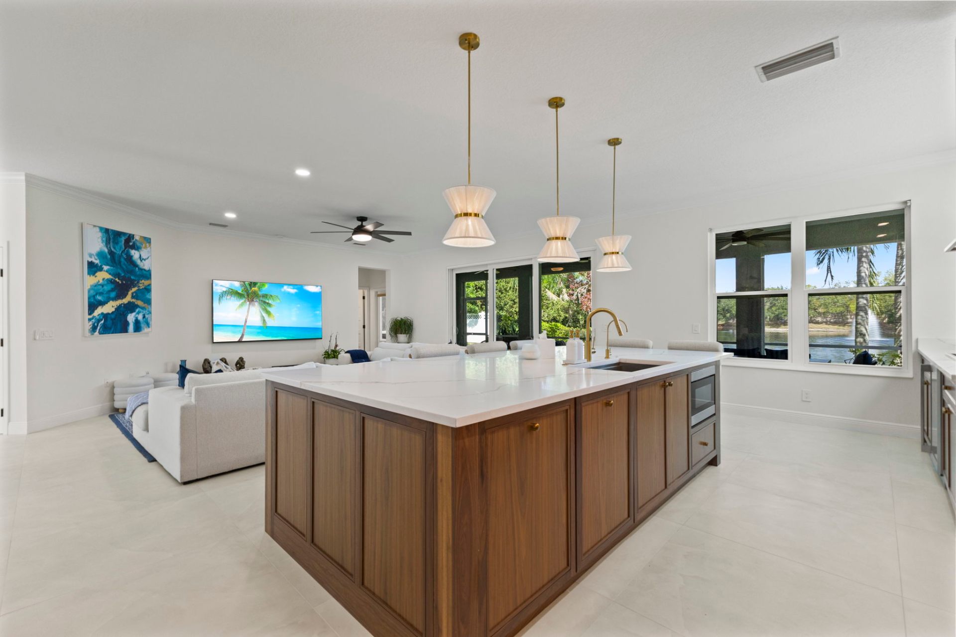 Open-concept walnut island with view of the great room and lake beyond