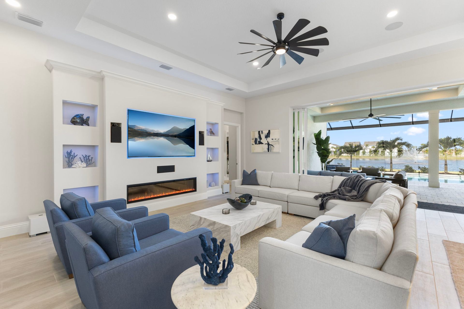 Open-plan living and dining room with lakefront views — interior design by Brenton Gold, Sarasota