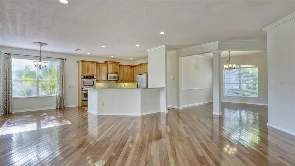 Before — open kitchen, dining and great room with original maple cabinetry